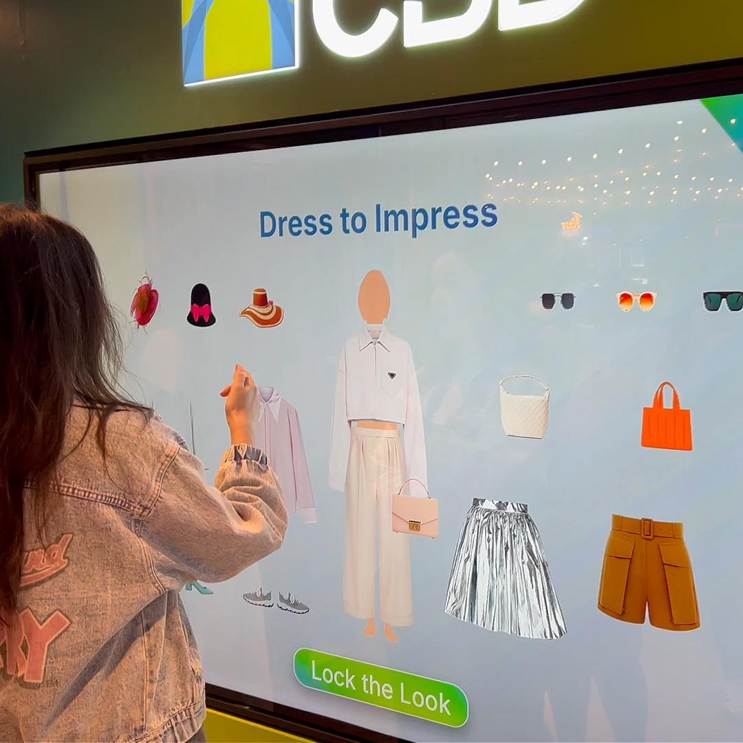 People playing a multi-level interactive financial literacy game at a brand activation event in Dubai, learning how to save and invest money.